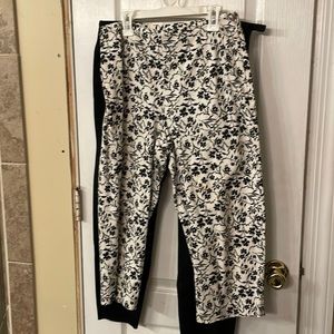 White capris pants with black floral design.